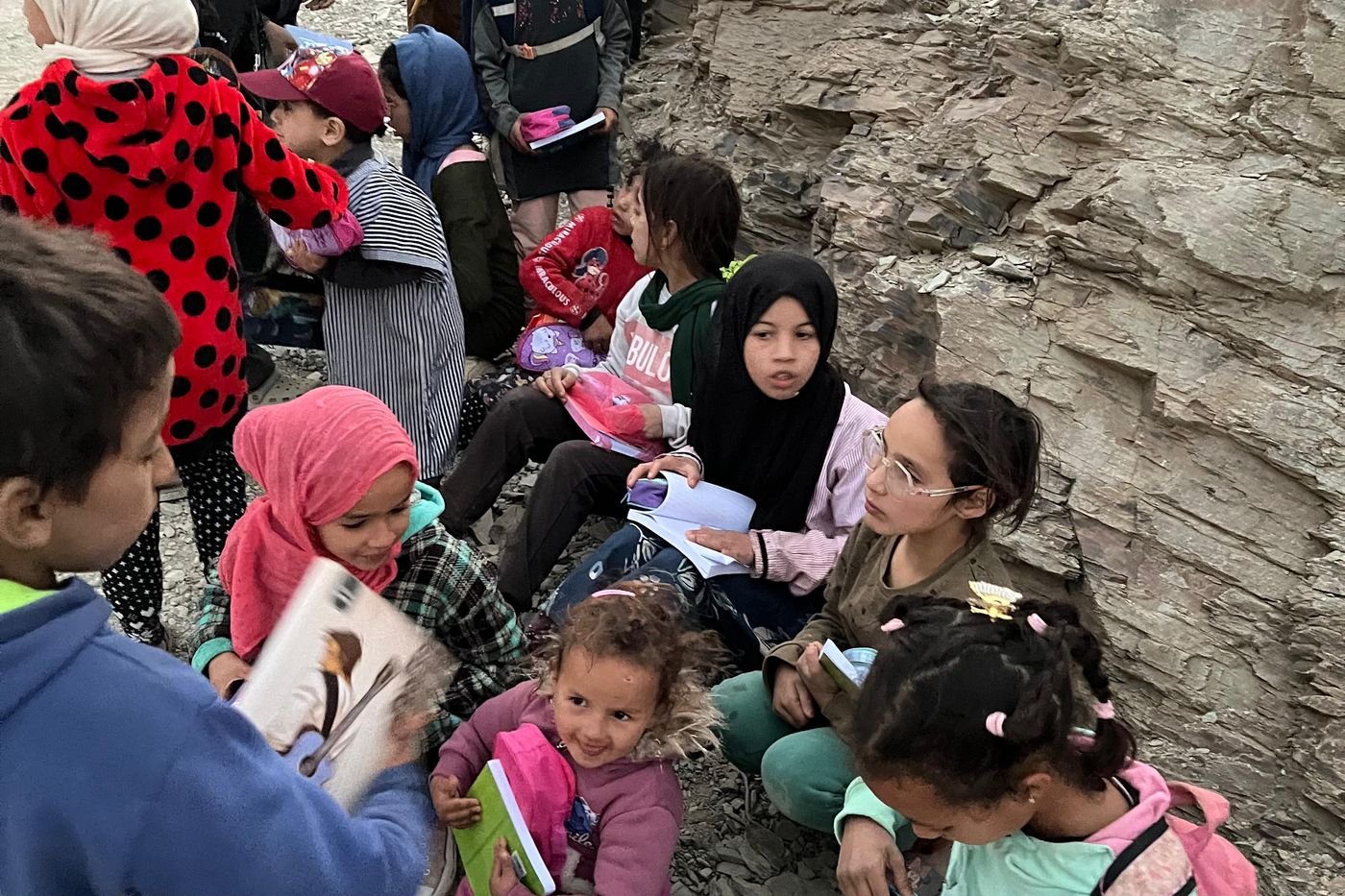 Children in a High Atlas village sitting with new backpacks and school kits