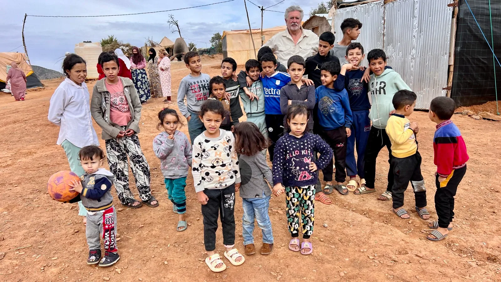 Children and families gather with David de Montaigne in Azgour during the November 2024 mission