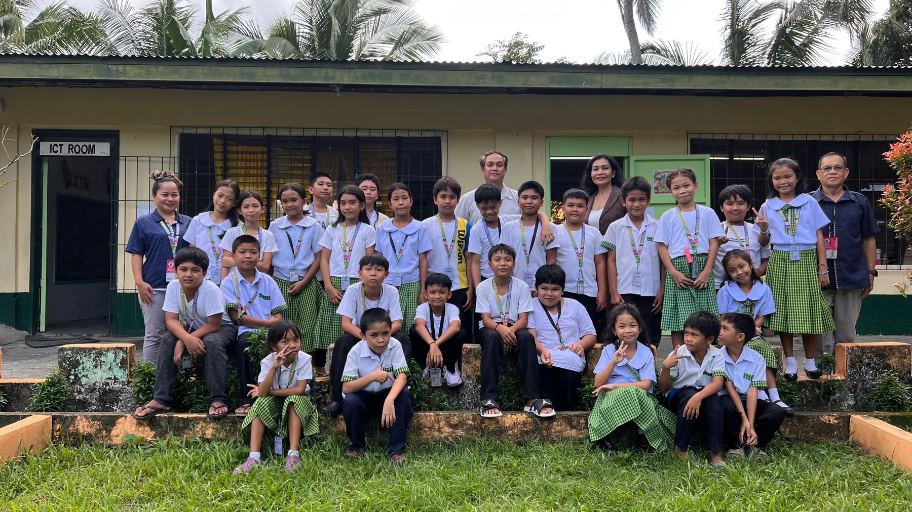 Maribeth de Montaigne with children and school staff during the August 2026 Iloilo follow-up visit