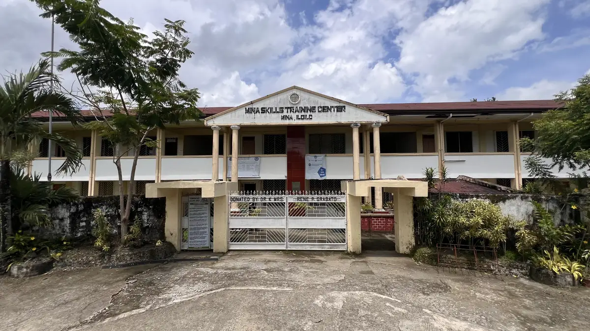 Front of the two-storey Mina Skills Training Center (Mina TESDA Center) in Mina, Iloilo, with its gate and name sign