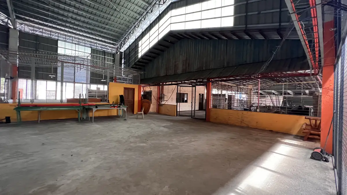 The open workshop hall inside the Mina Skills Training Center, with work tables and a high steel roof