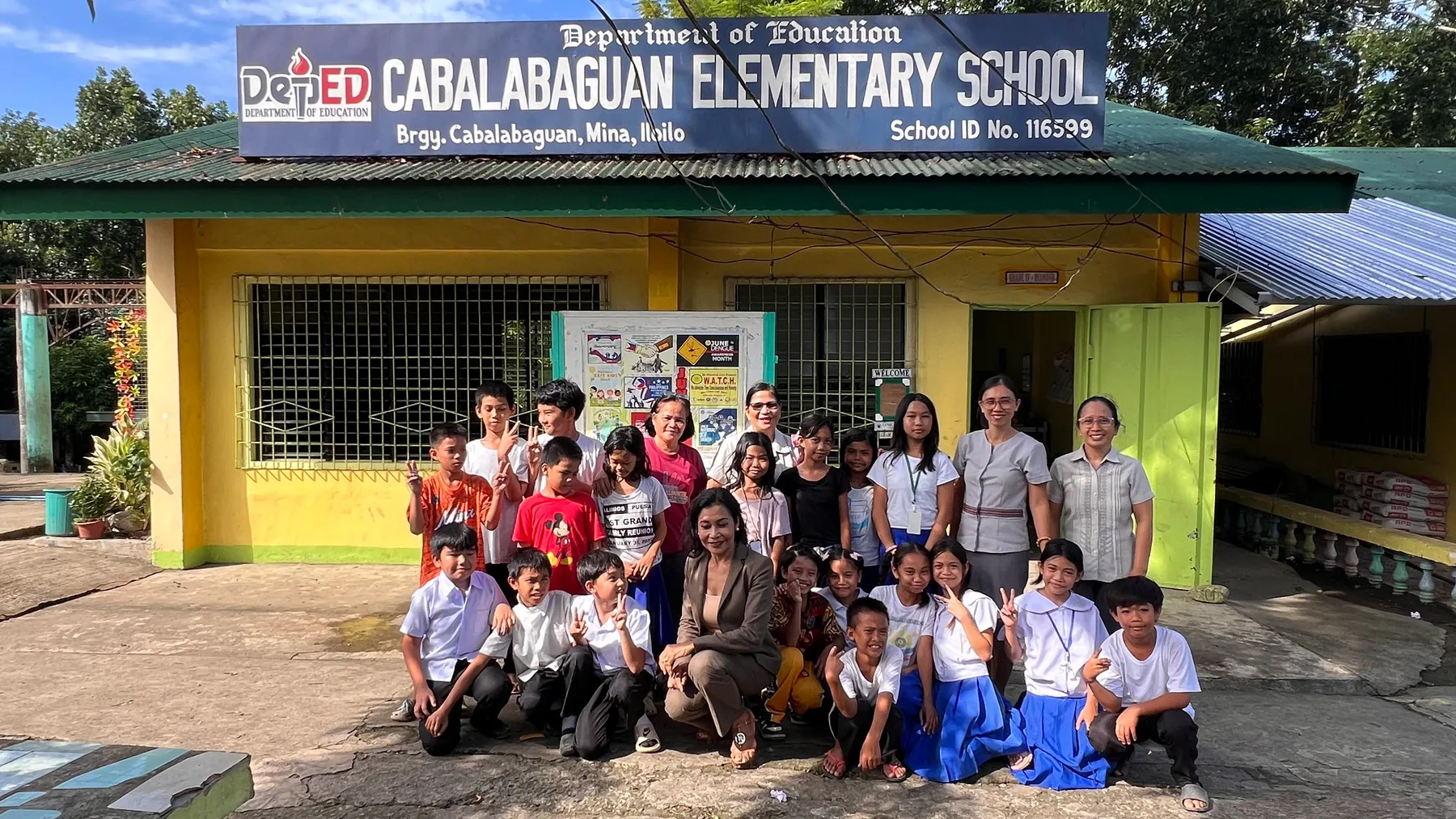 Children, teachers and local representatives gather during the August 2026 follow-up