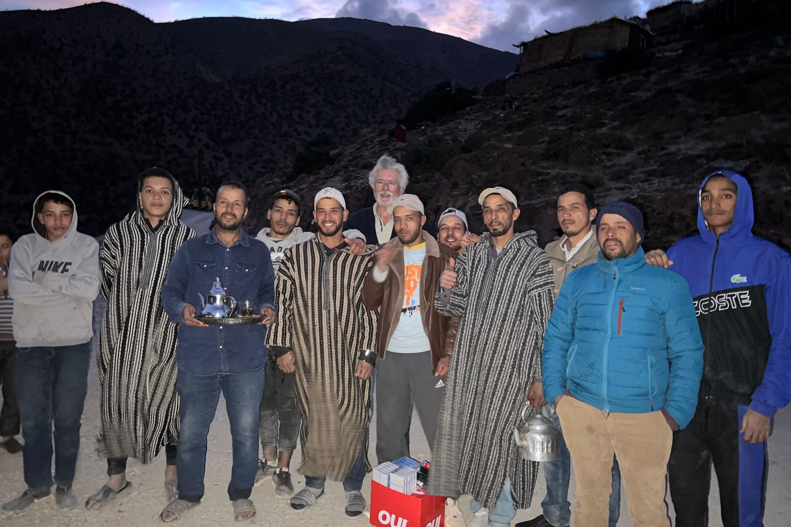 The School Aid mission team standing with local men in a mountain village