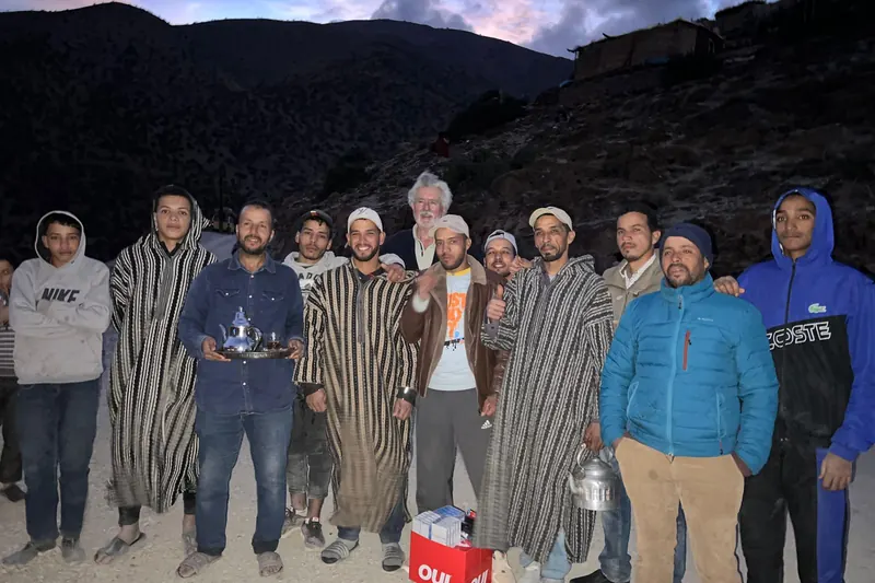 The School Aid mission team standing with local men in a mountain village